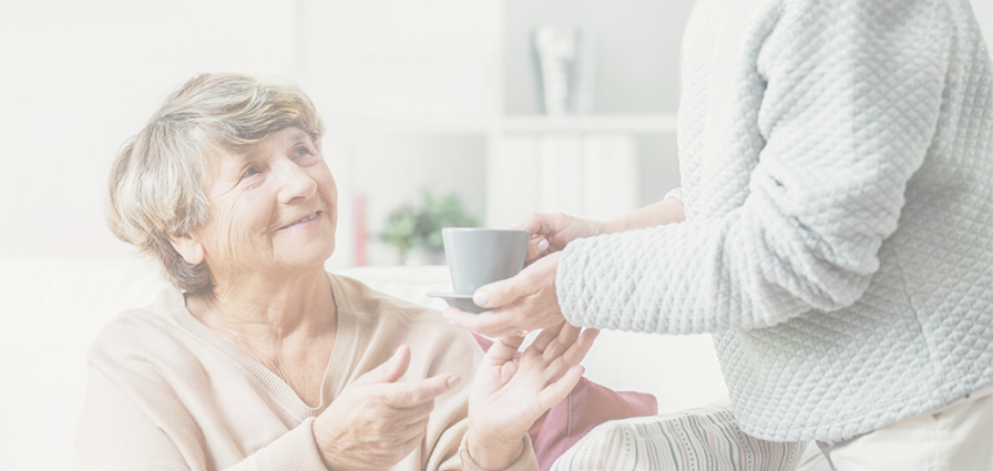 Senior woman receiving a drink.