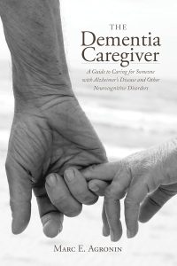 Book cover of “The Dementia Caregiver,” showing an adult holding an older person’s hand, symbolizing support and care for Alzheimer’s and dementia